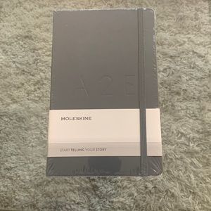 Brand new and unopened grey moleskine notebook